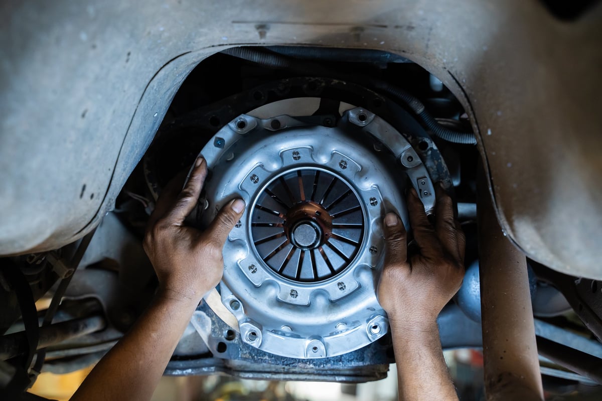 Mechanic working on a car clutch system at 1st Wheels Garage