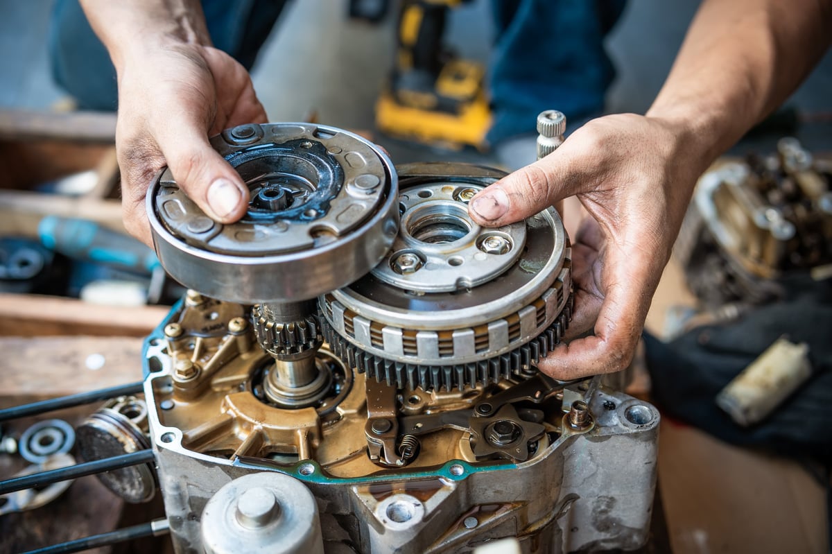 Mechanic repairing a vehicle engine at 1st Wheels Garage