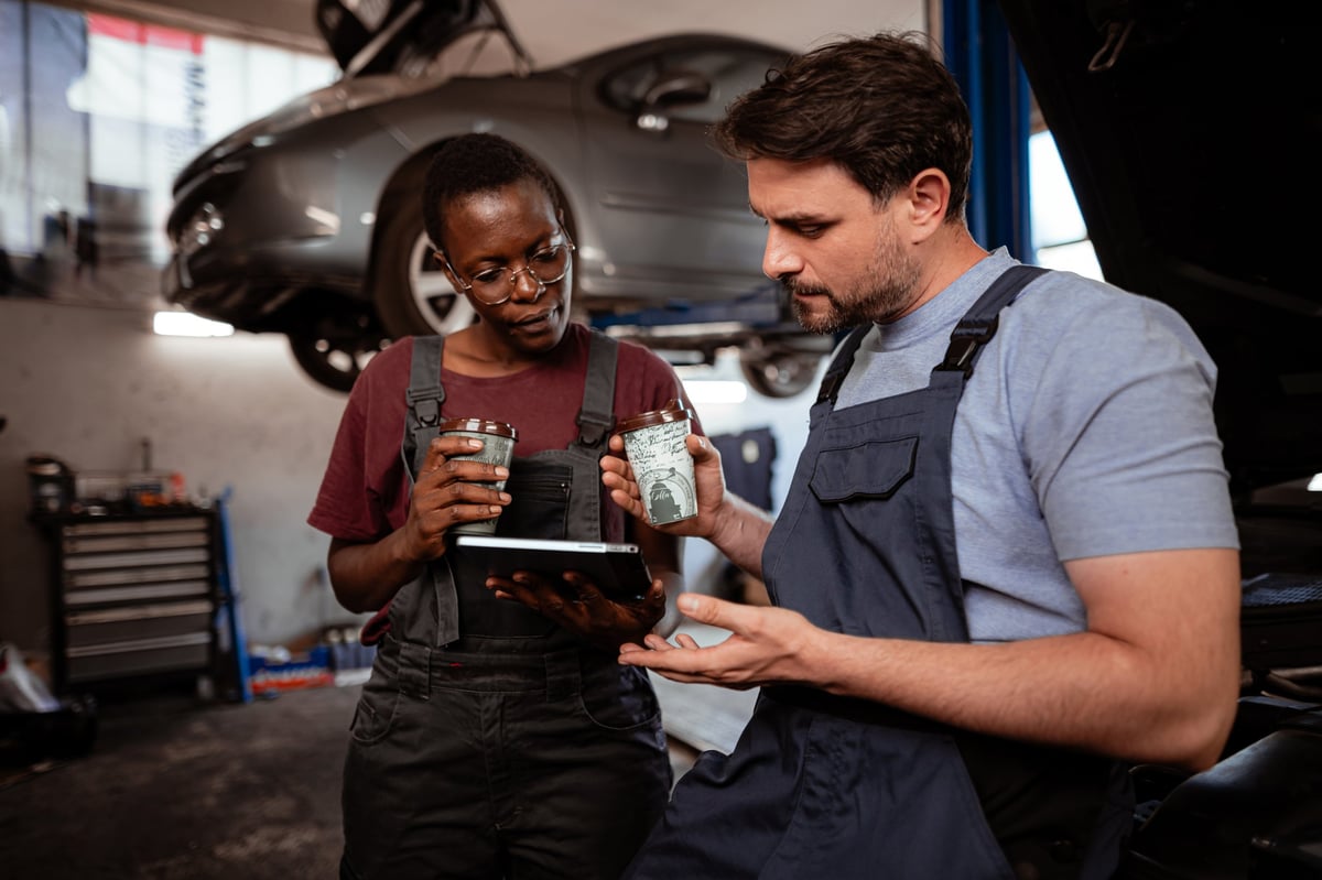 Mechanics discussing car repairs at 1st Wheels Garage