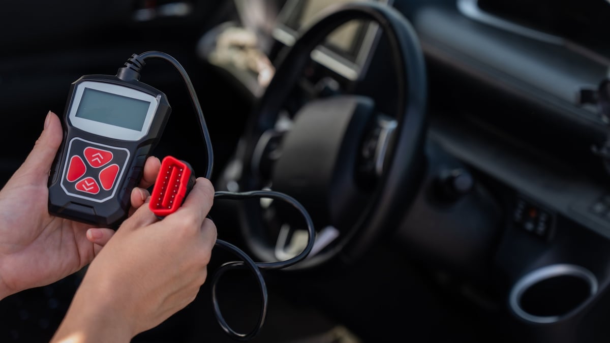 Using an OBD2 diagnostic scanner on a vehicle at 1st Wheels Garage
