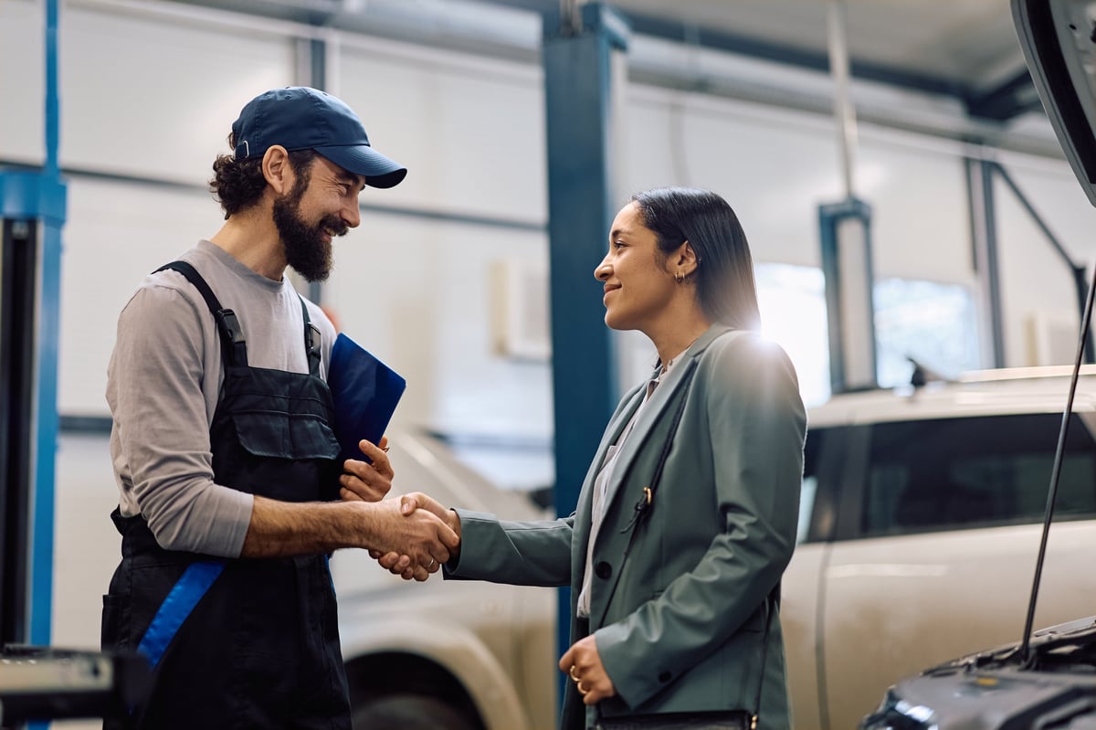 Mechanic shaking hands with a happy customer at 1st Wheels Garage