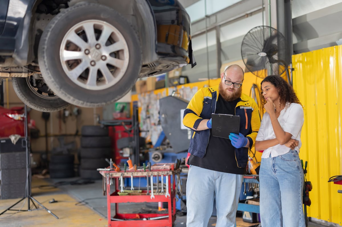 Mechanic explaining a repair to a customer at 1st Wheels Garage