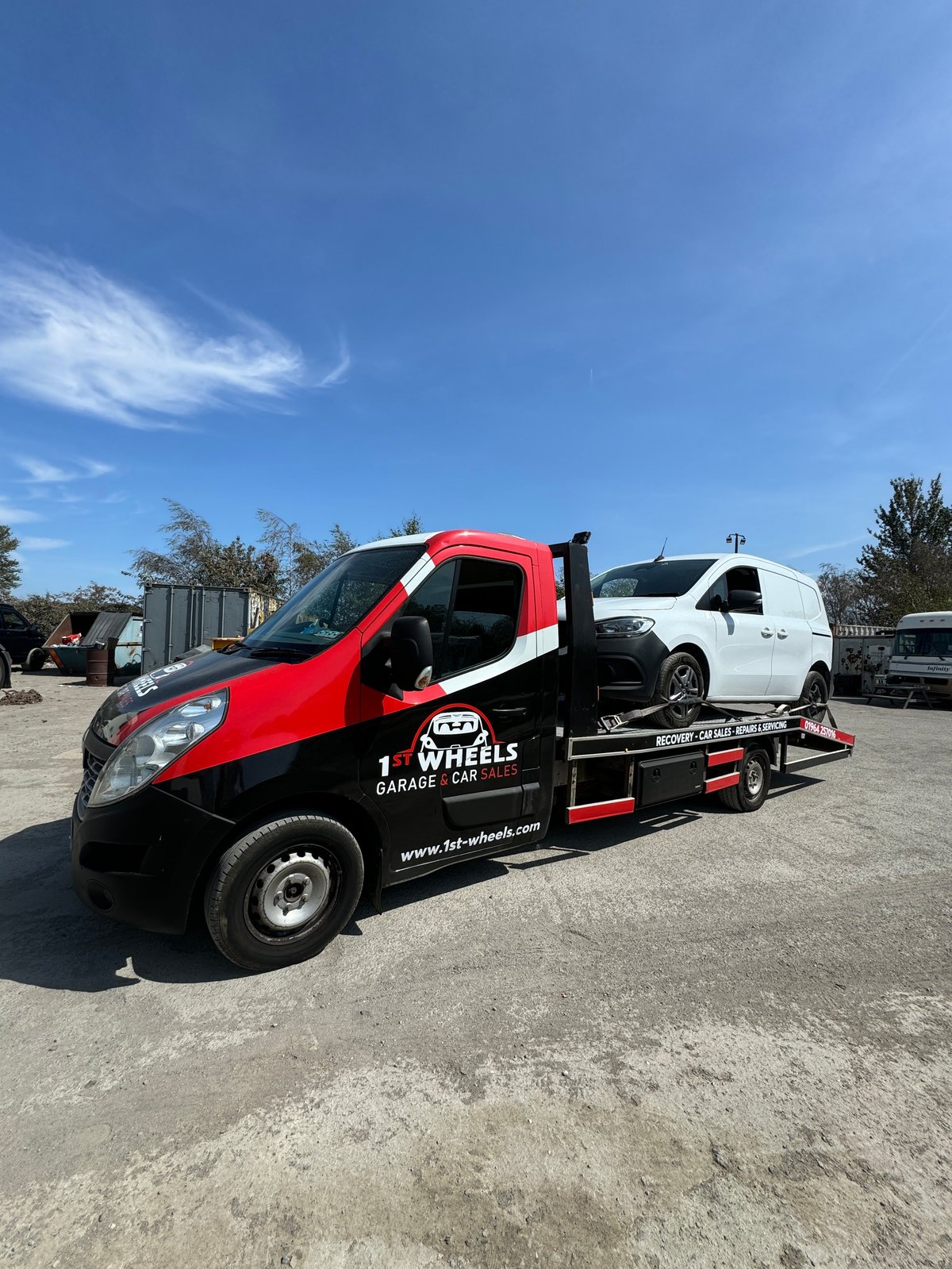 1st Wheels Garage pickup and collection service with a recovery truck on a flatbed